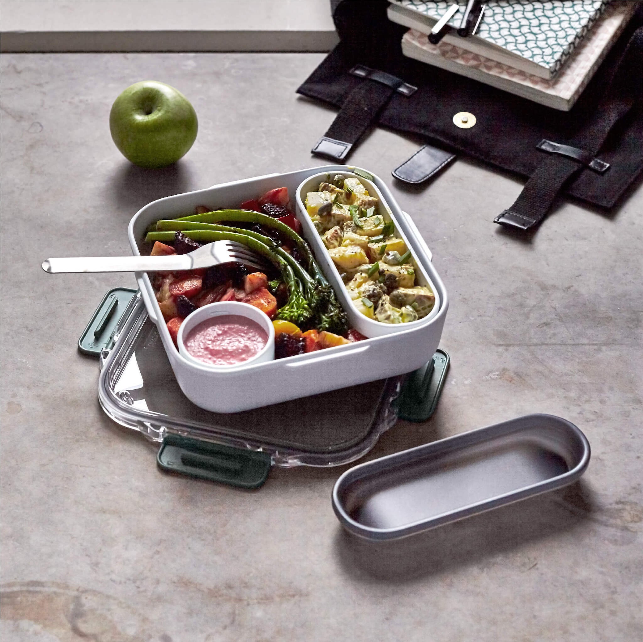 olive color lunch box tupper with cutlery with salad inside