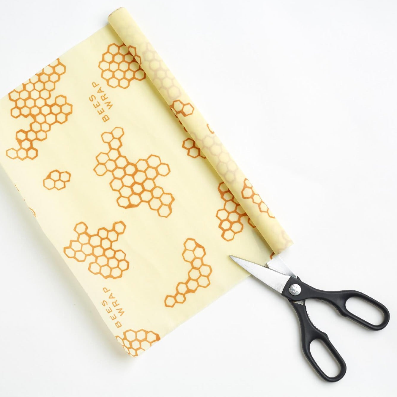 XXL beeswax wrap being cut with scissors